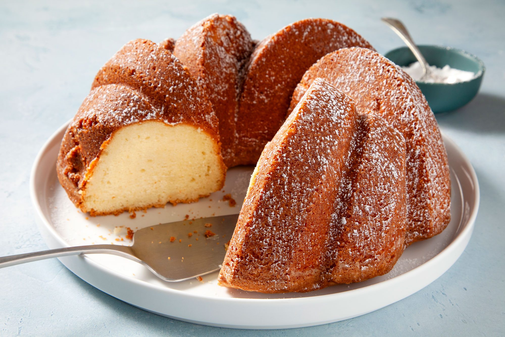 Buttermilk Pound Cake sliced and served with powdered sugar on top