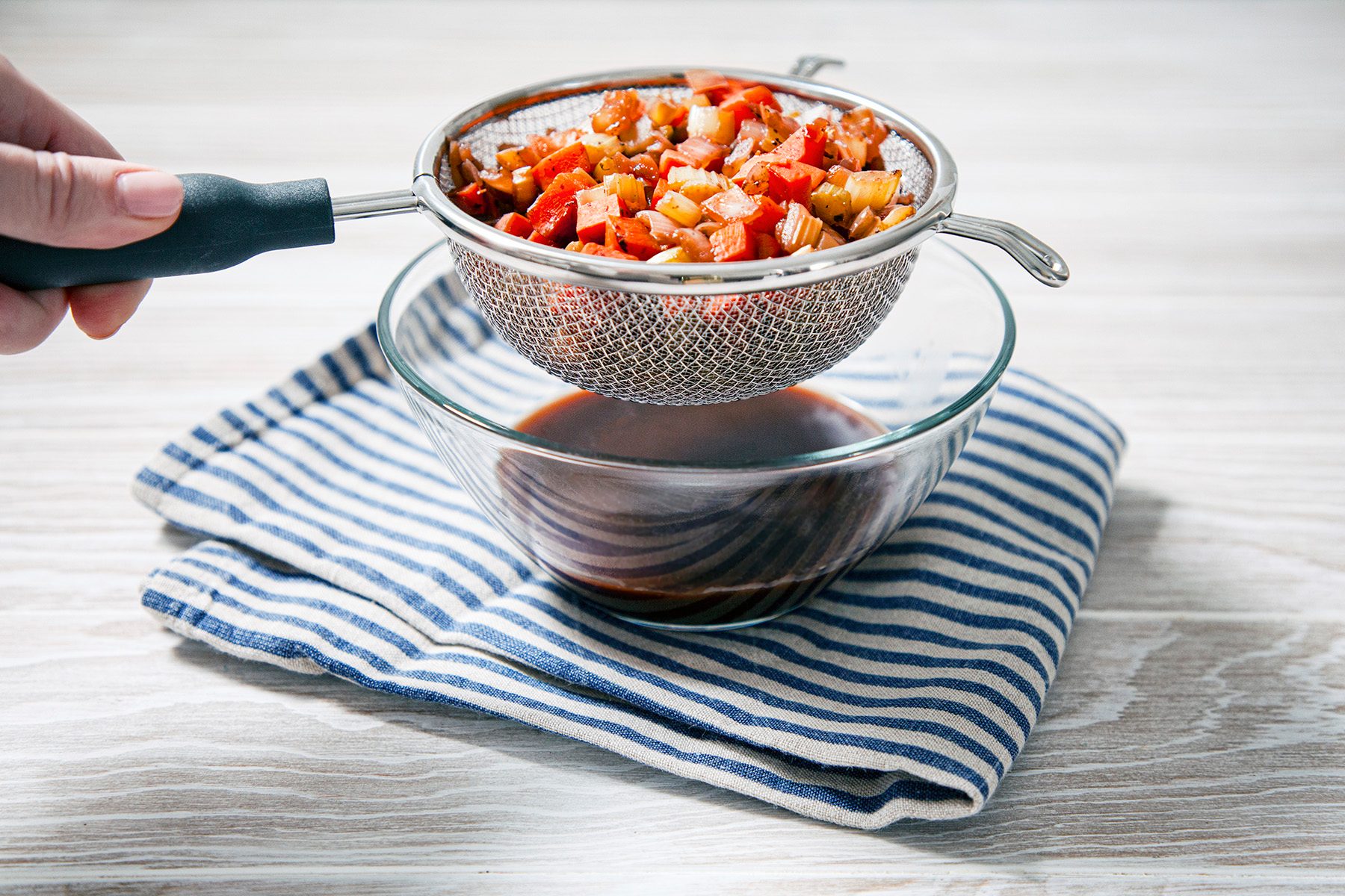 Table view shot of straining through a fine sieve