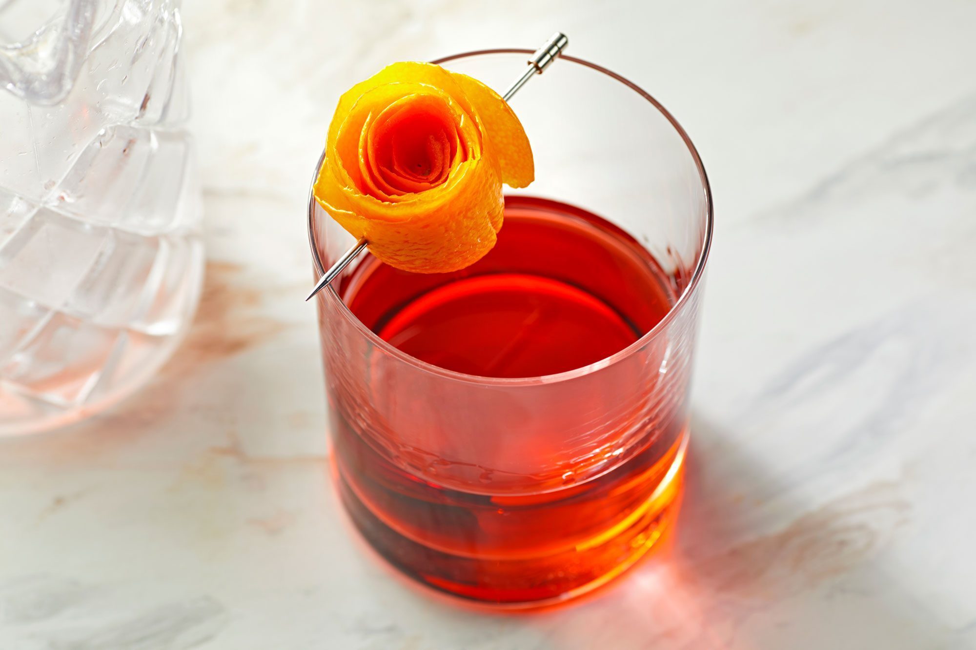 negroni served in a rock glass; marble surface;