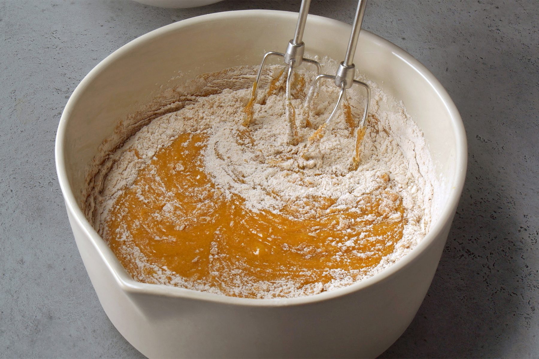 combined flour, cinnamon, baking soda and salt in a large bowl; gradually beating into pumpkin mixture until blended; blending machine