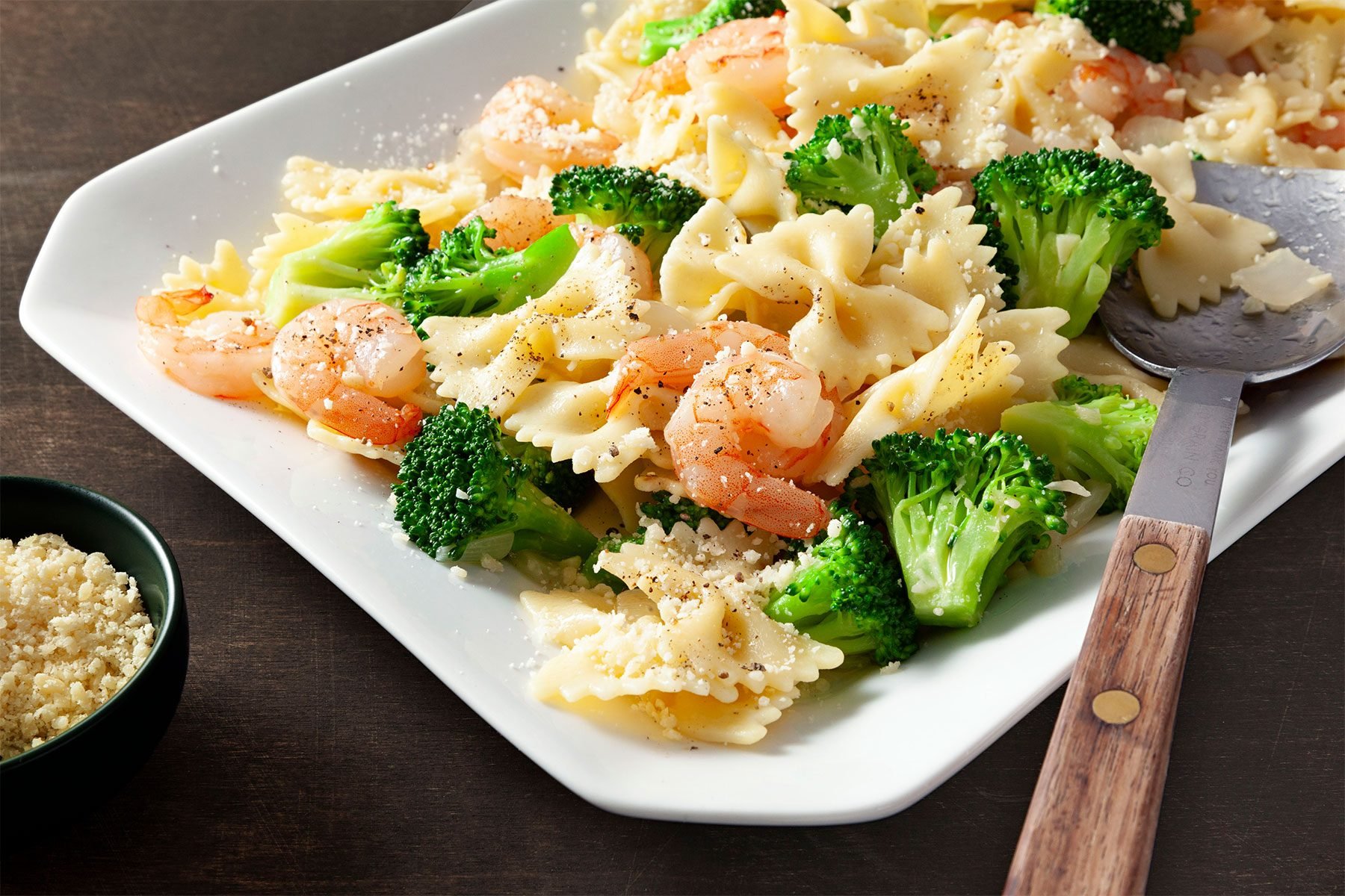 close shot of broccoli shrimp pasta toss