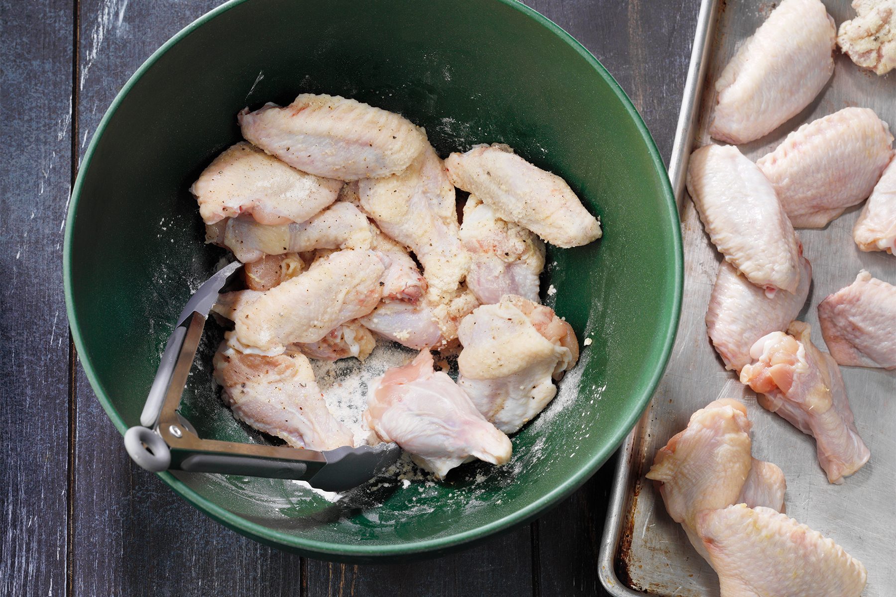 A bowl of chicken meat and a pan of food 