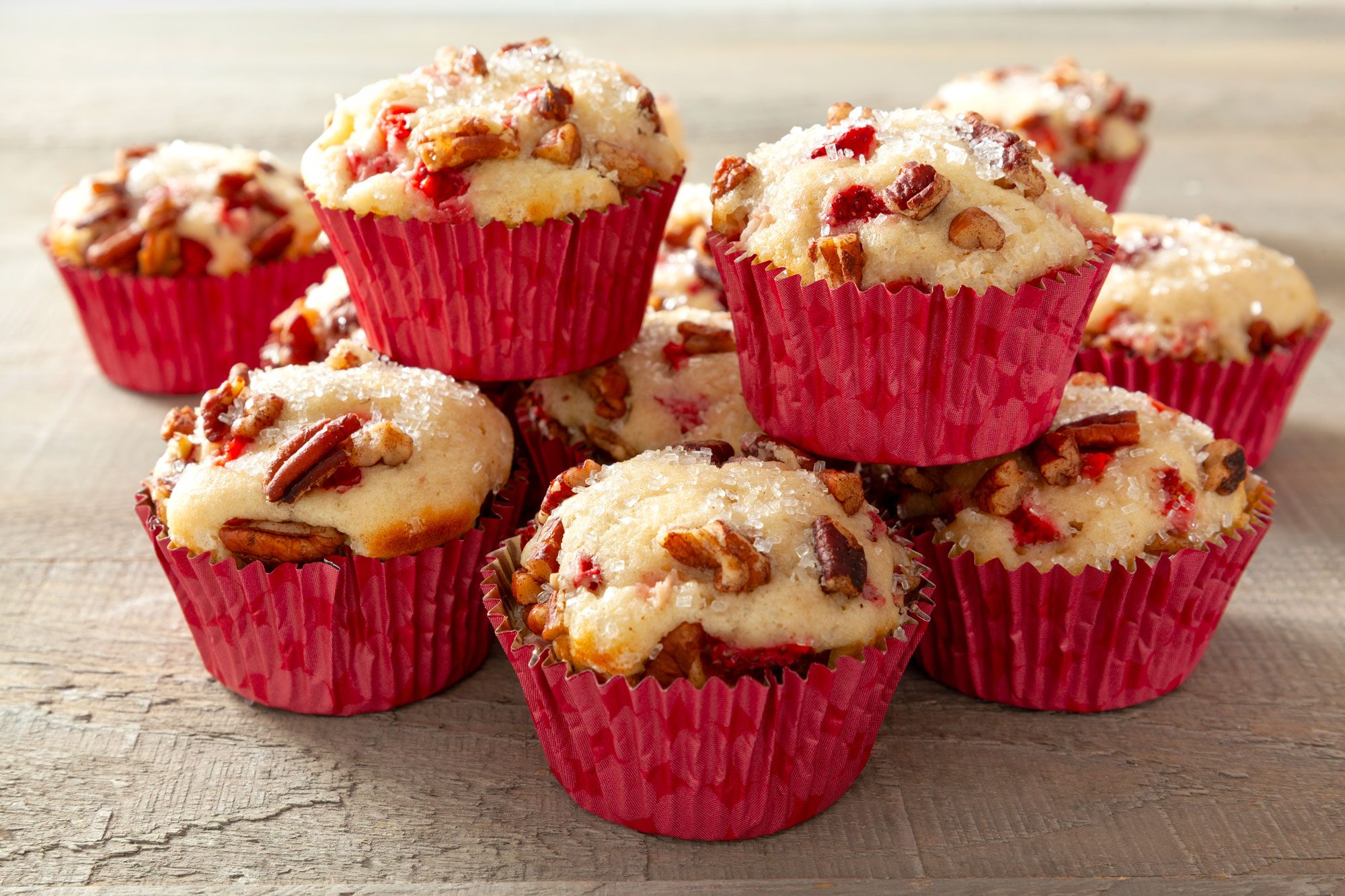 Stack of Strawberry Muffins on a Wooden Surface