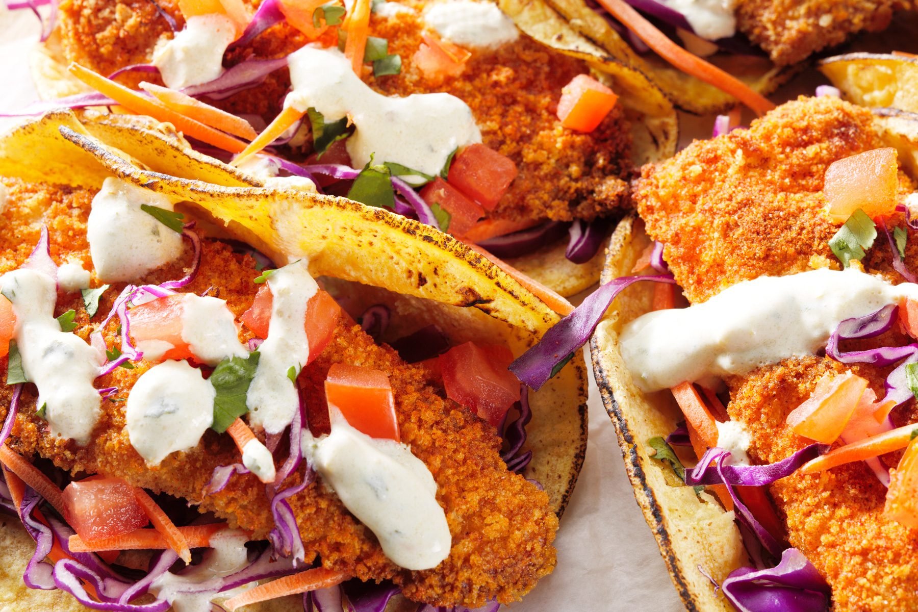 Air-fryer fish topped with tomatoes, shredded cabbage, and carrots