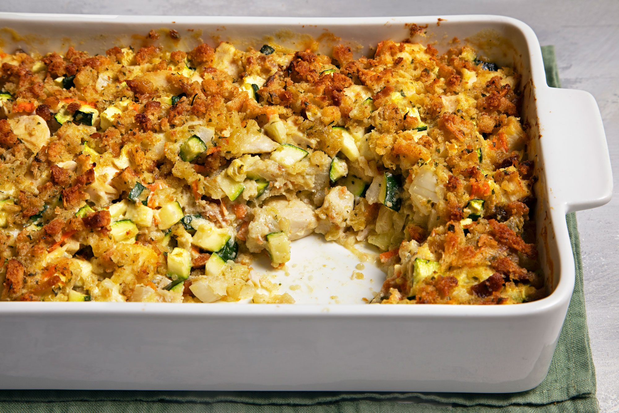 close shot of chicken zucchini casserole in a baking dish