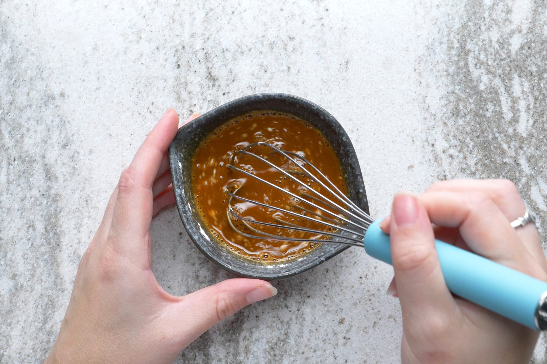 A person Stirring the bouillon in the boiling water