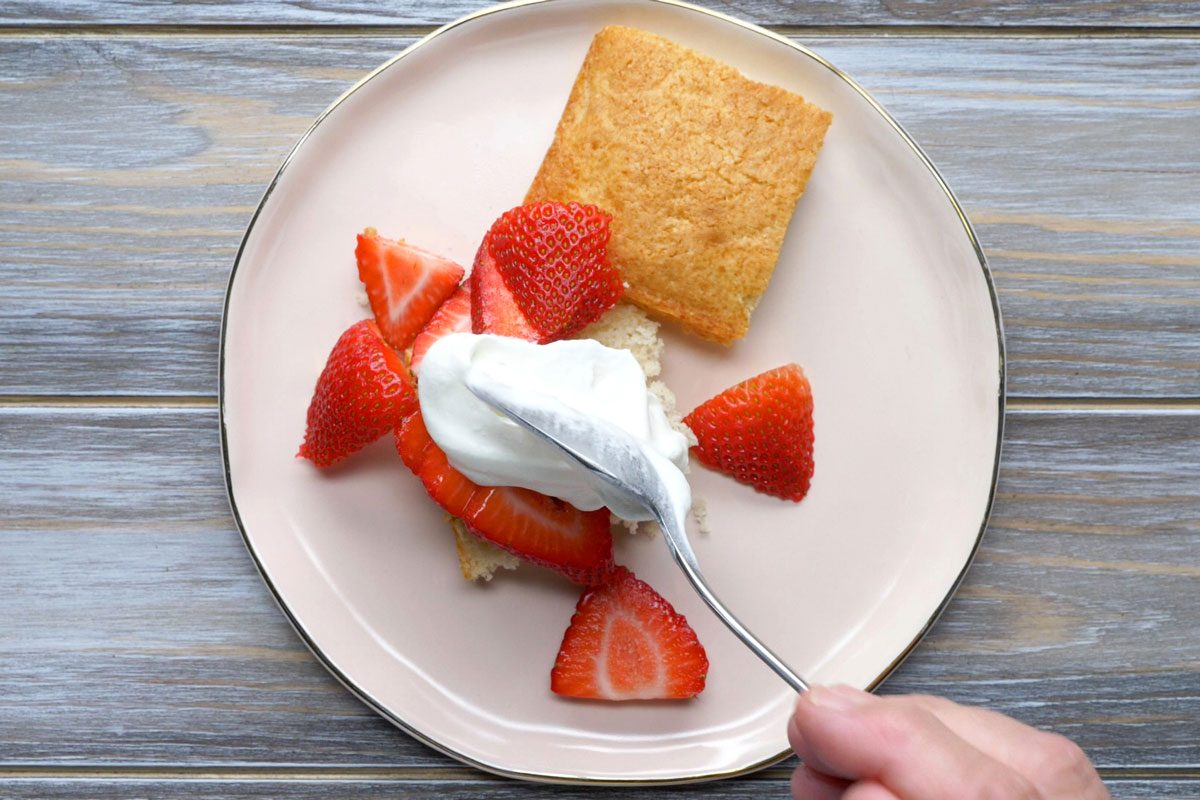 Dollop some of the whipped cream and the strawberries