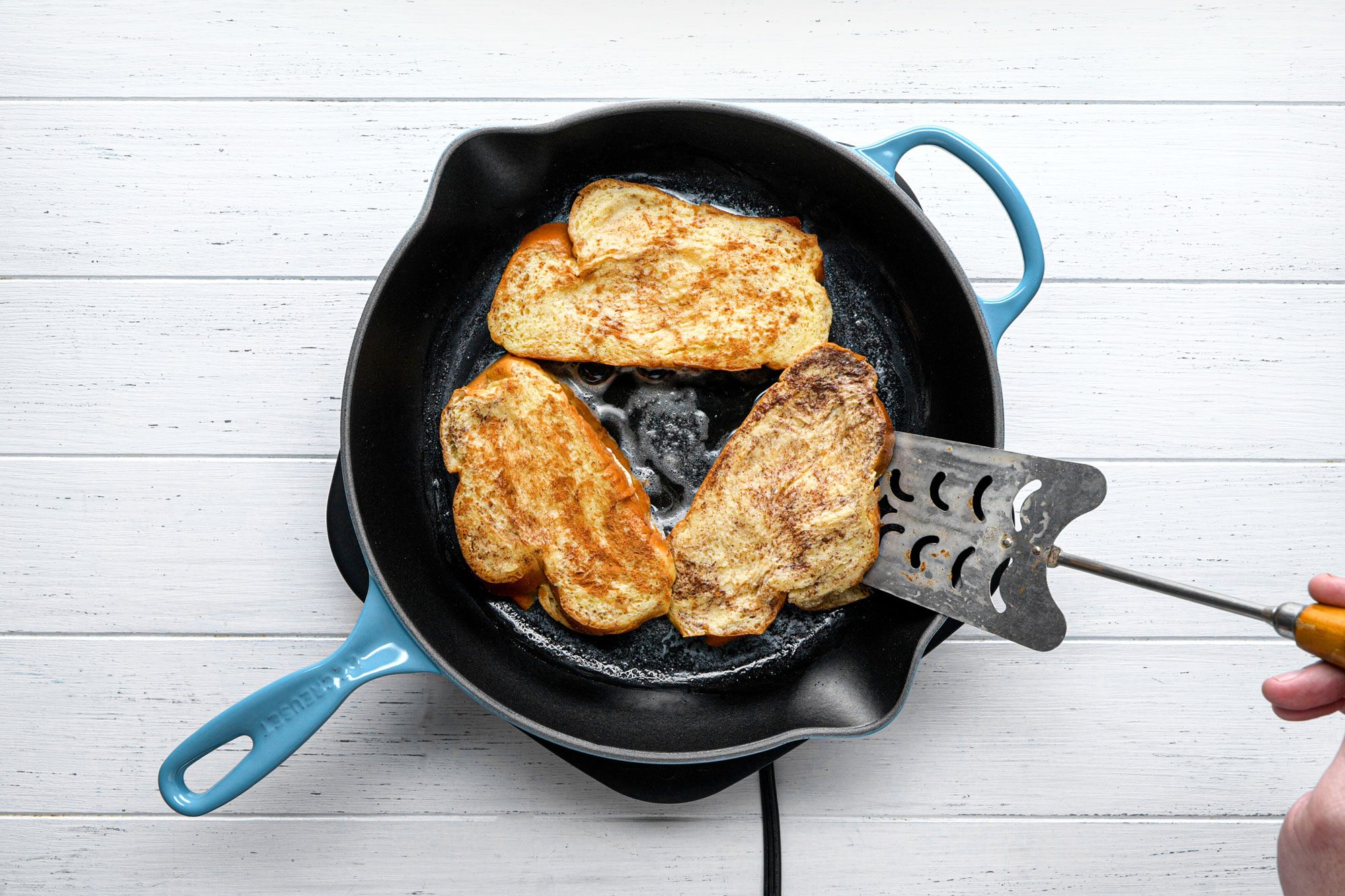 overhead shot of dipped bread slices toasted on pan