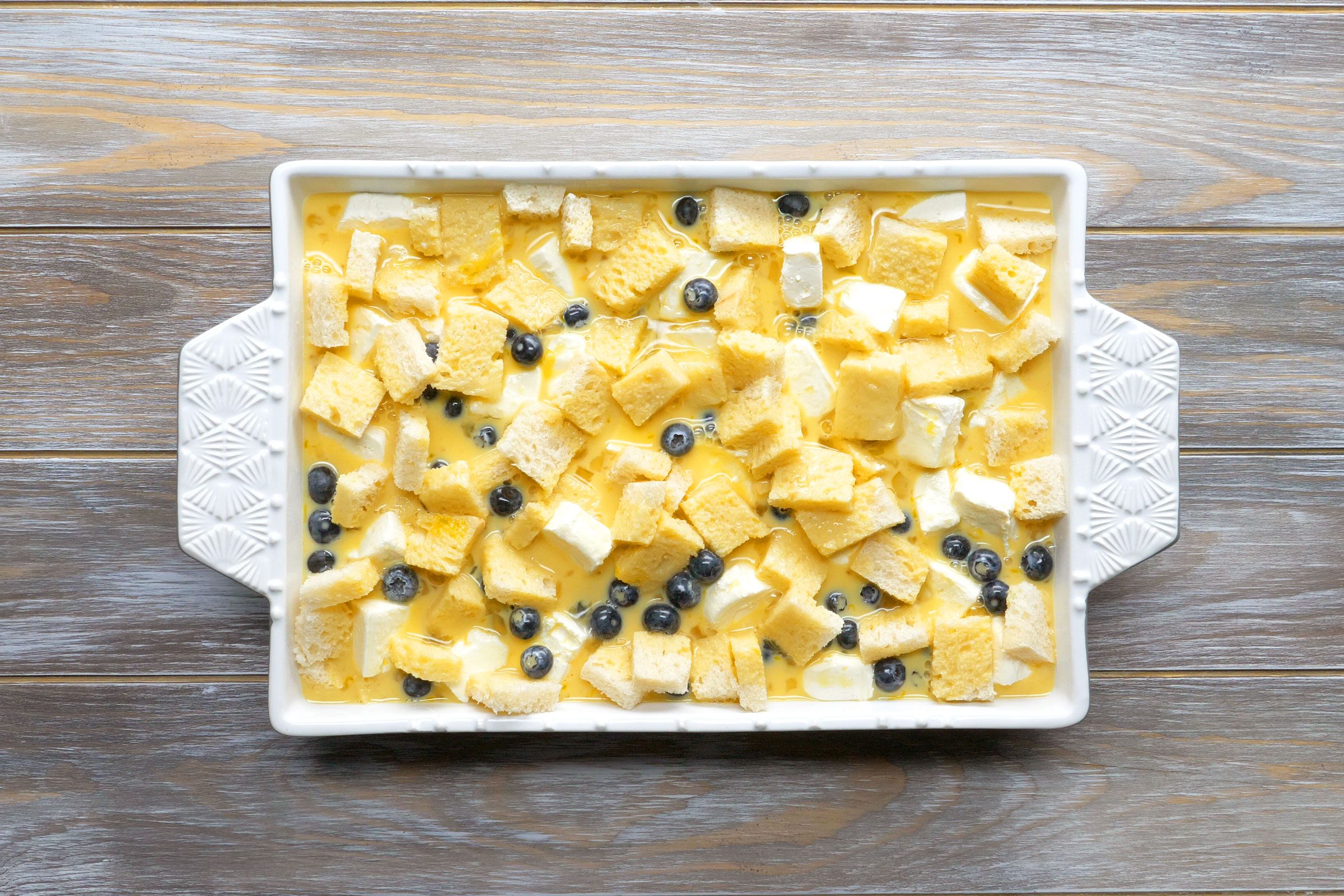 13x9-inch baking dish with blueberry french toast before baking