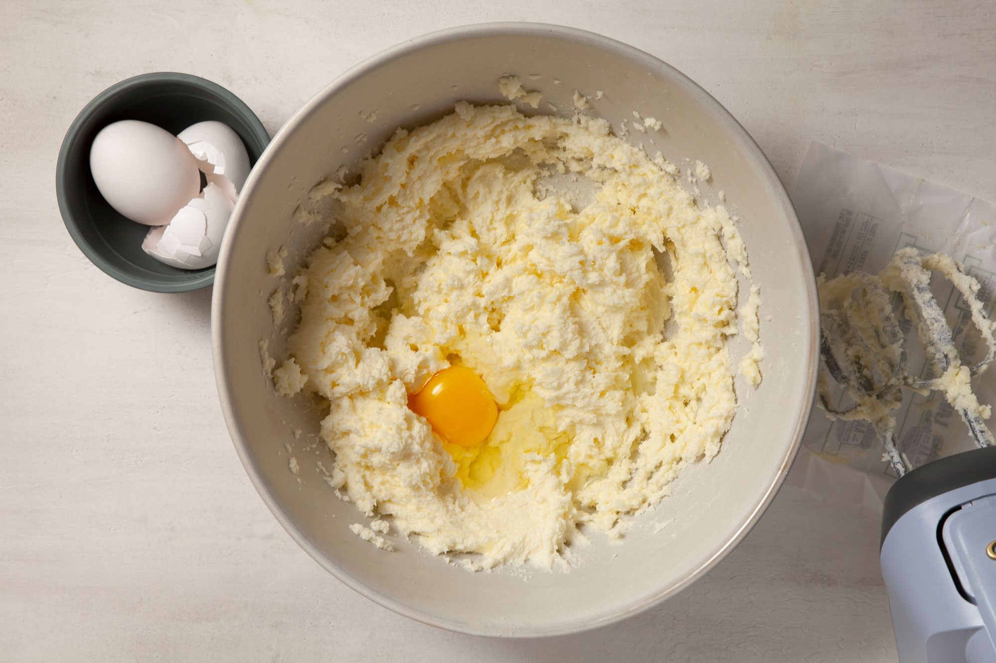 Overhead shot of a large bowl; beat cream butter and sugar; until light and fluffy; add eggs; marble background;