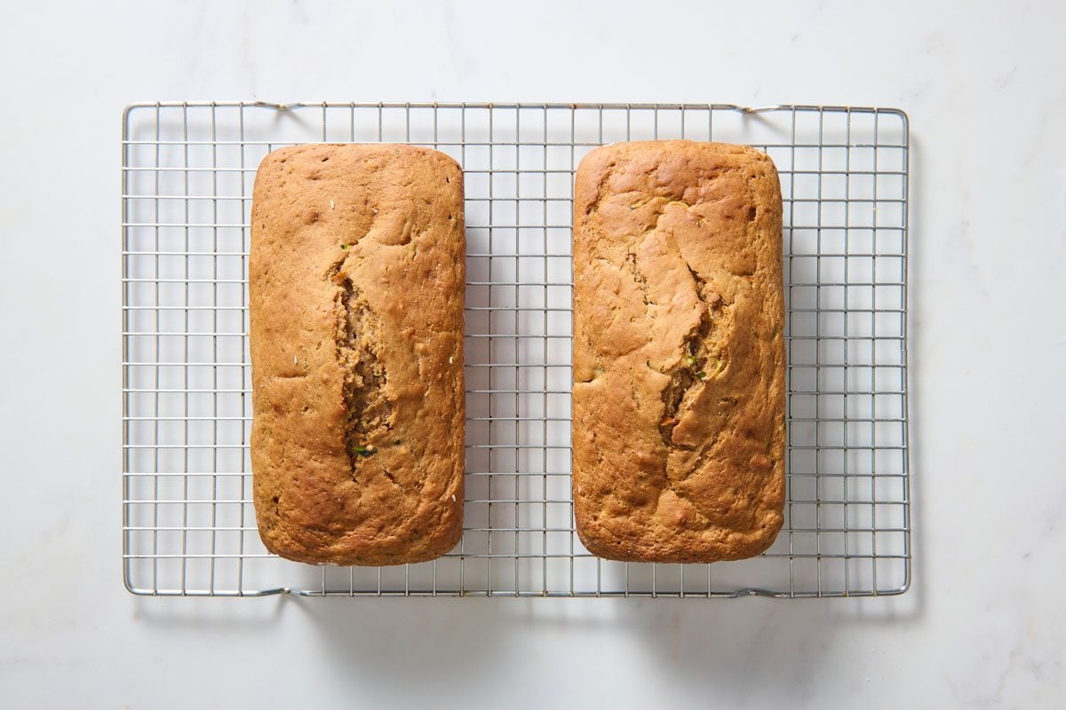 two baked loaves of zucchini carrot bread on cooling rack