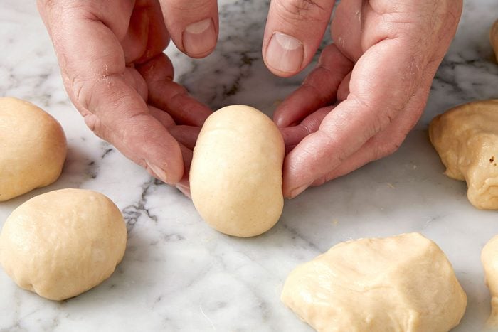 rolling dough into small balls; marble surface