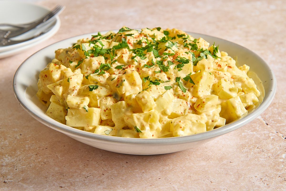 Closeup image of Cajun potato salad in a bowl topped with paprika and parsley