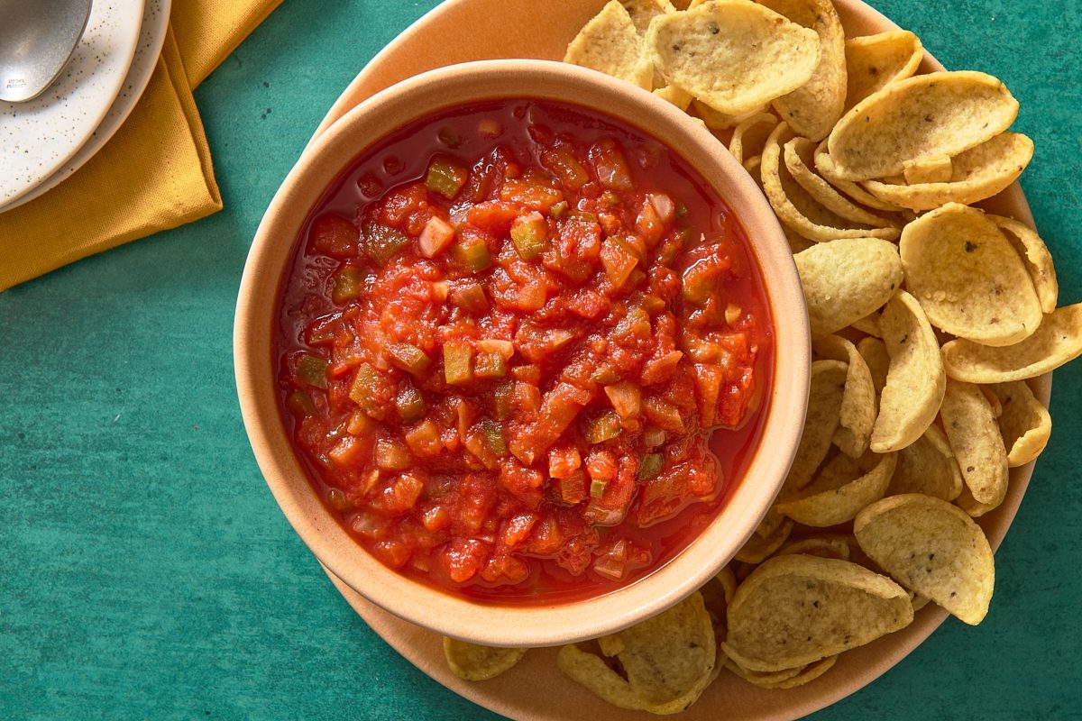 Overhead shot of chunky salsa in a bowl with some chips