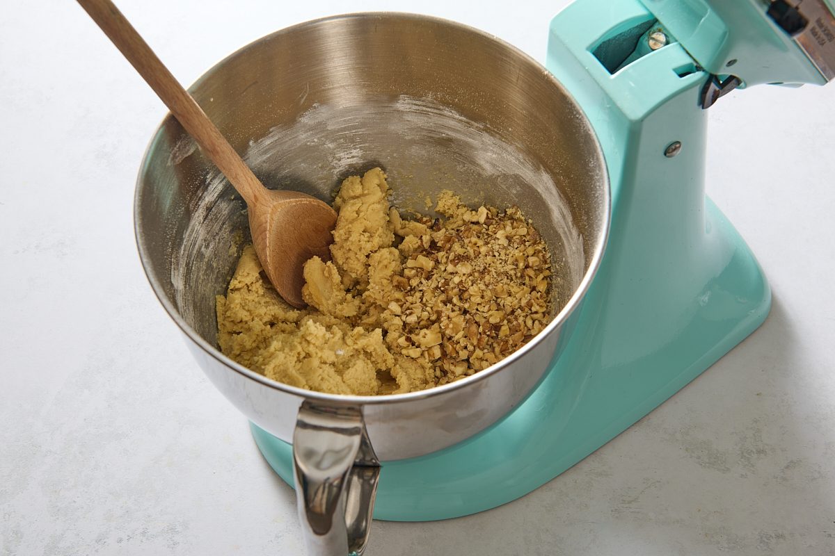Dry ingredients and nuts being added to the batter