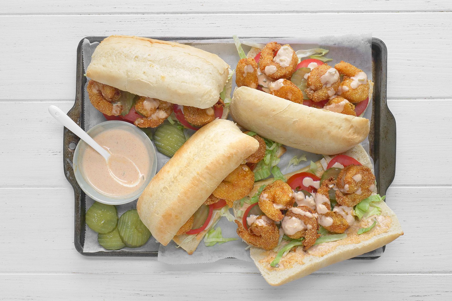 overhead shot; white background; Shrimp Po'Boys served on rectangular tray