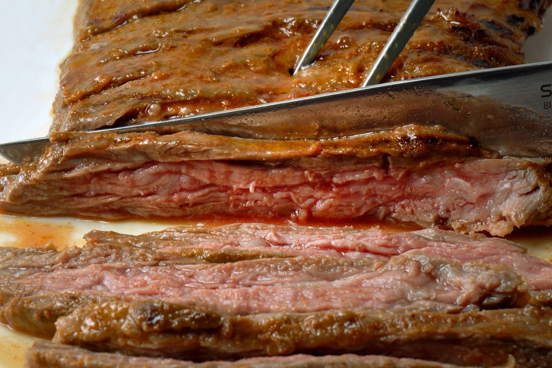 Slicing the skirt steak carefully with a knife