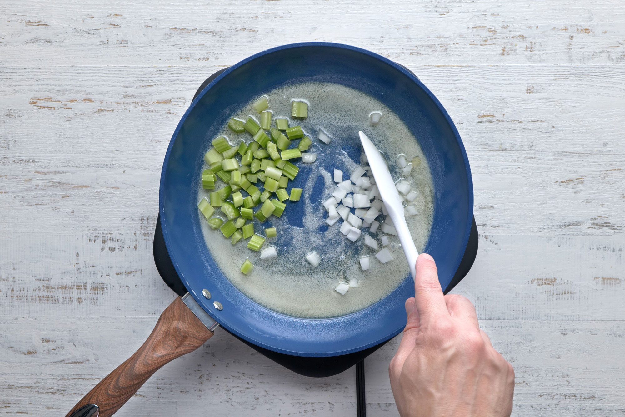 Onions and celery cooked in butter in a large skillet