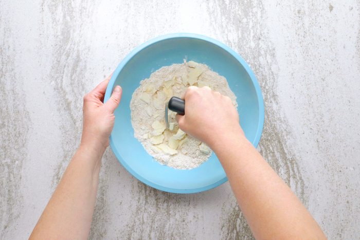 making the crust in a bowl for peach crisp