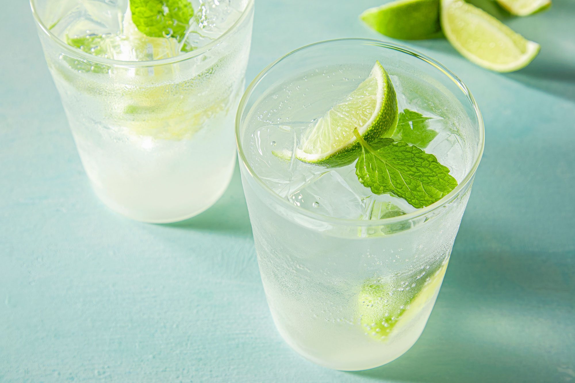 Virgin Mojito served in two glasses garnished with additional lime