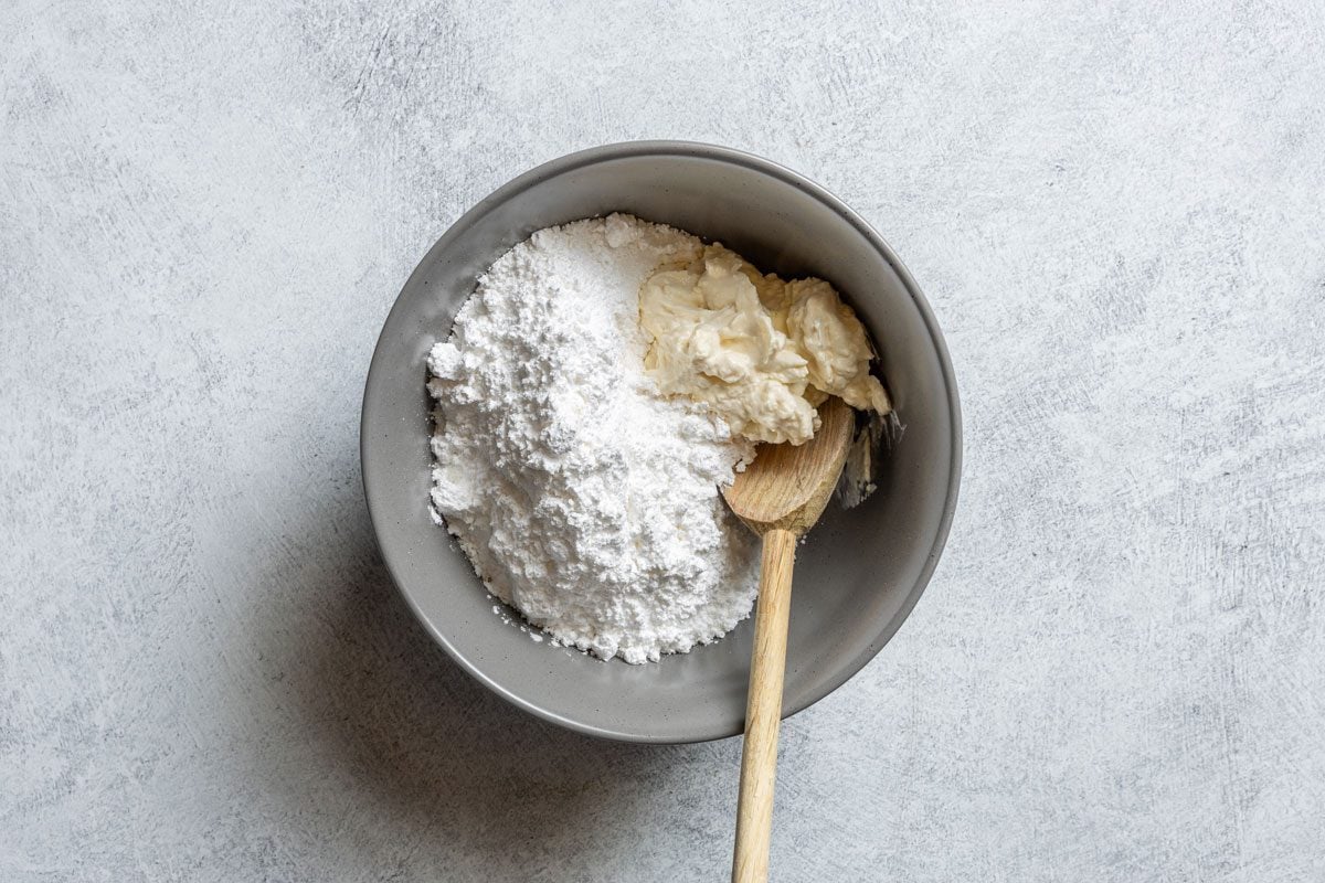 Mixing Cream Cheese And Butter And Milk And Vanilla Extract for Zucchini Cake frosting