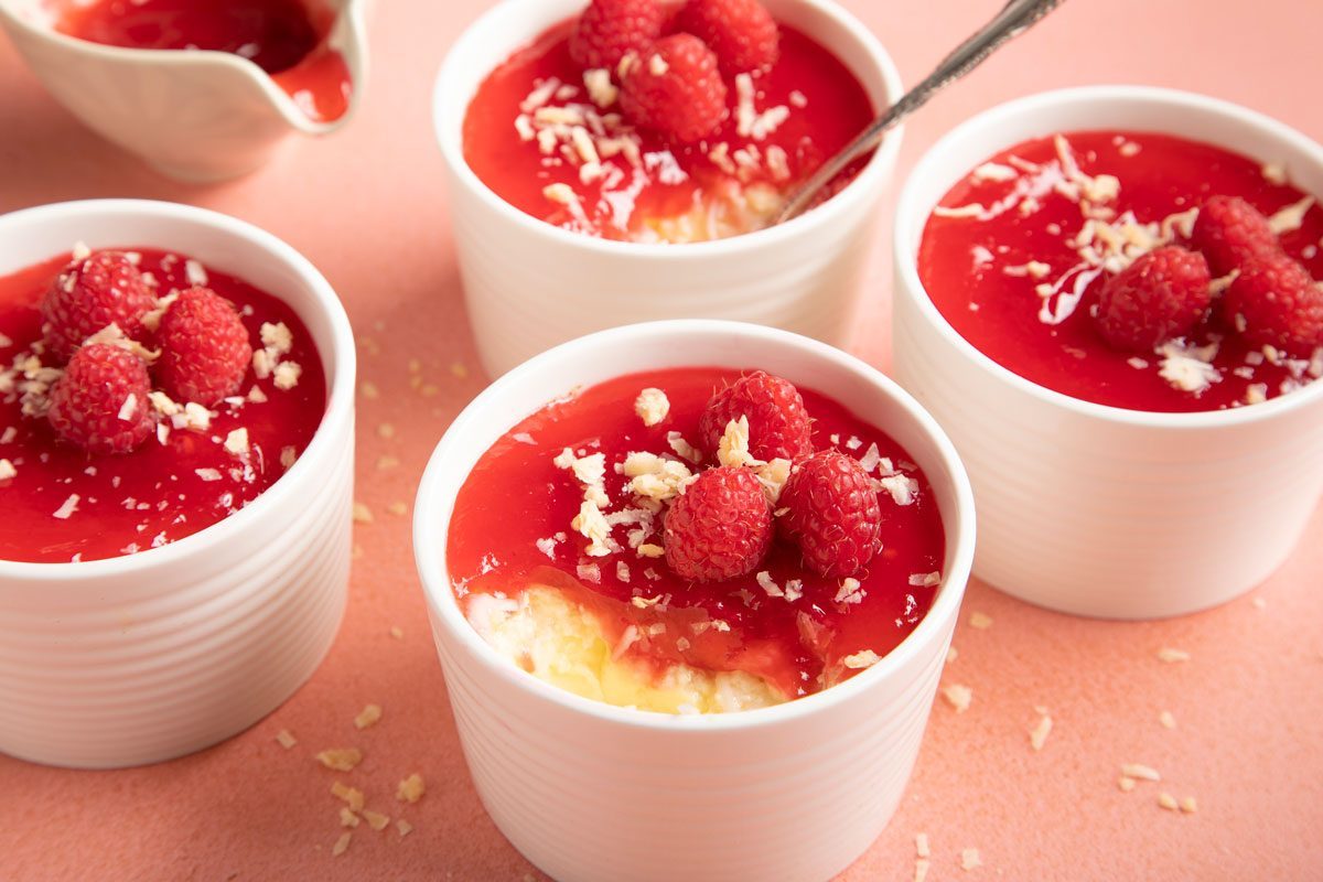 Coconut Custard topped with raspberry in small ramekin dishes 