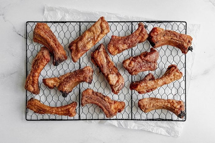 Taste Of Home Fried Ribs On A Wire Rack On A Marble Surface.