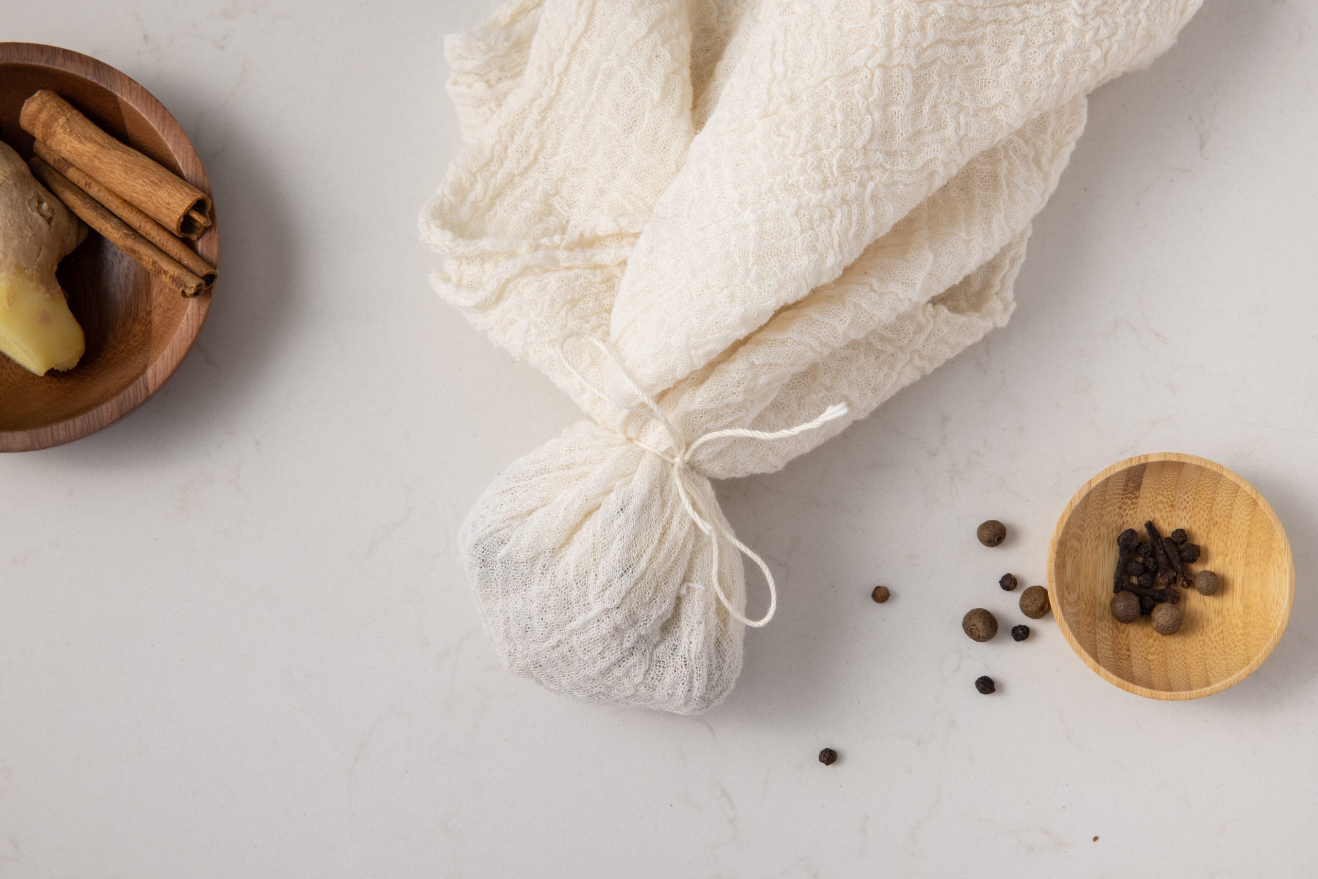 Spices in cheesecloth to make spice bag.