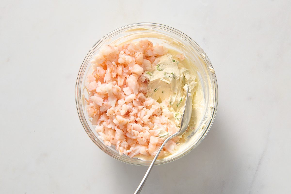 Combining shrimp rangoon ingredients in a bowl