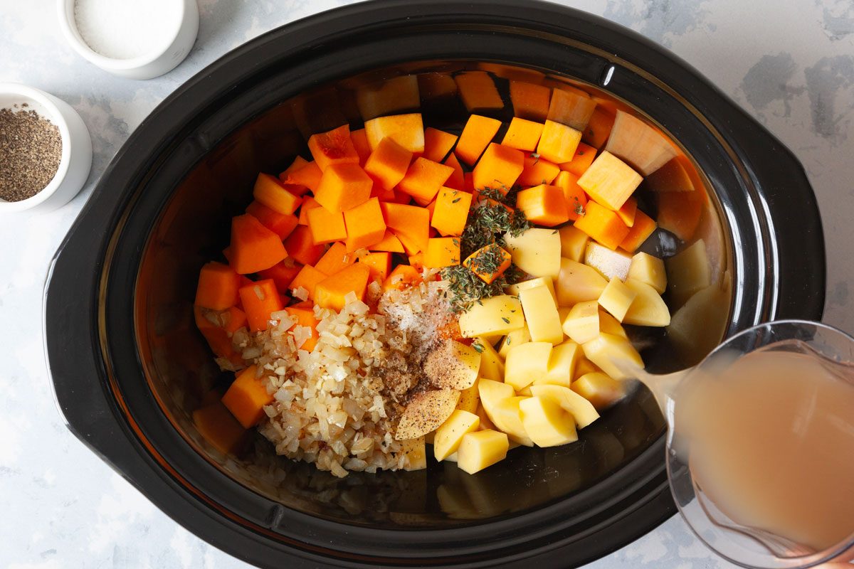chopped butternut squash, potato, onion, garlic, fresh thyme, salt, pepper and chicken broth in a slow cooker before cooking