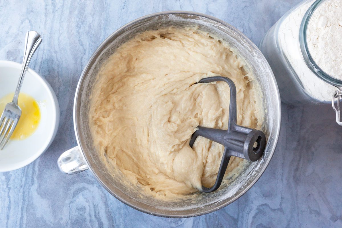 Step 2 of Taste of Home Amish Cinnamon Rolls is to let the yeast bloom and add the warm water, mashed potatoes, butter, eggs, sugar, milk powder, salt, vanilla and flour (5 cups). Beat this mixture until smooth and then stir in enough of the remaining flour to make a soft dough