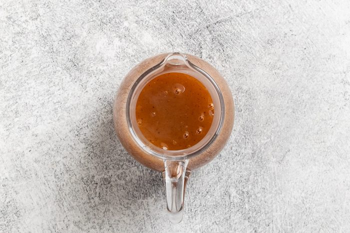 Taste of Home Apple Syrup recipe photo of the syrup transferred to a pouring vessel.