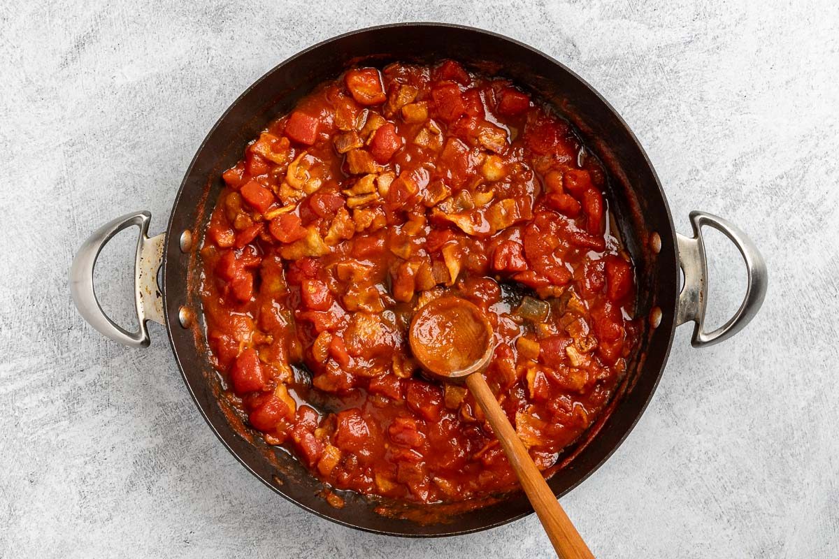 Taste of Home Bacon Pasta recipe photo of the tomato paste and diced tomatoes added to the skillet.