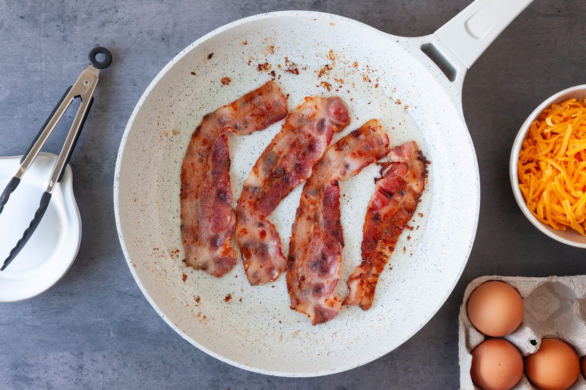 Step 1 of Taste of Home Bacon and Egg Muffins is to cook the bacon is a skillet And Egg Muffins Tohd24 36194 Sarahtramonte 1