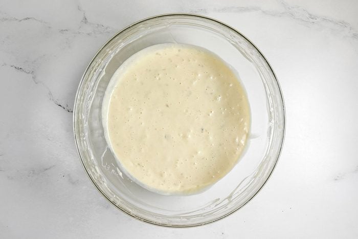 Batter for Taste of Home Banana Coffee Cake in a glass bowl on a marble surface