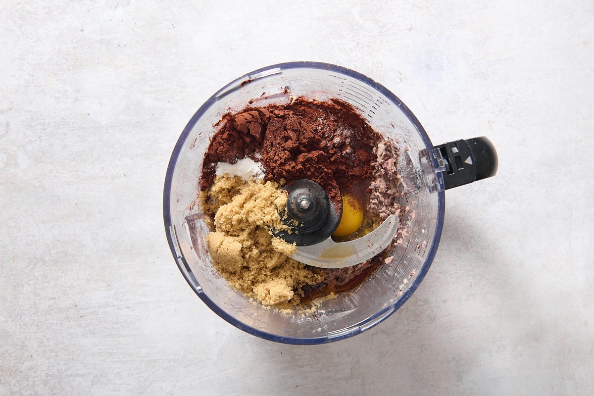 Ingredients for black bean brownies inside a food processor
