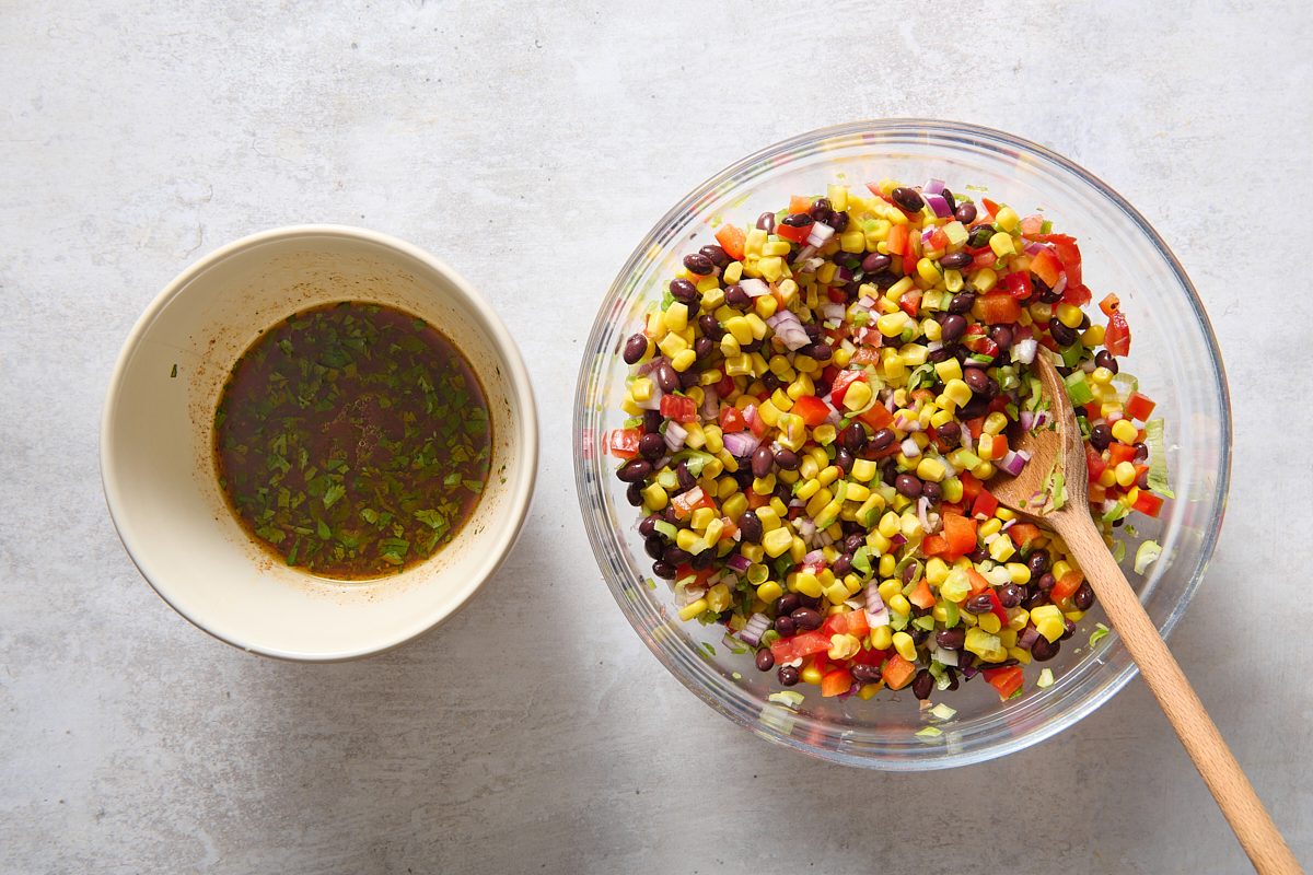 Combining the black bean salad ingredients in a large bowl