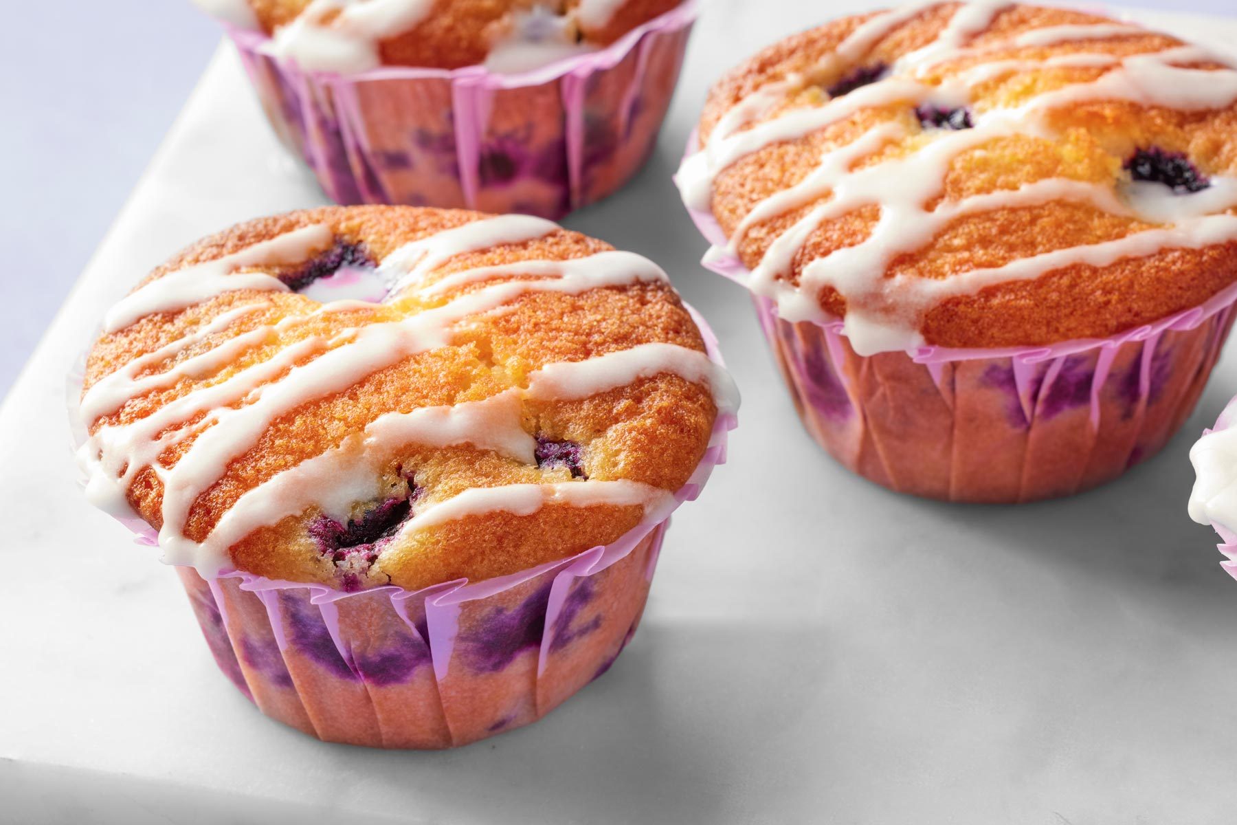 Close up shot of blue berry lemon muffins with glaze on top