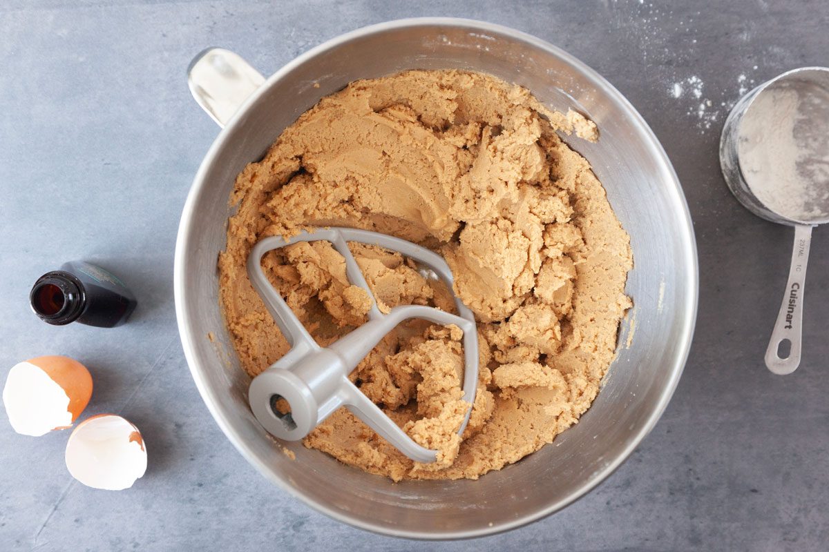 Step 2 of Taste of Home Butter Pecan Cookies is to cream brown sugar and remaining butter until light and fluffy, about 5 to 7 minutes. Beat in egg yolk and vanilla. Gradually add flour, and continue to mix until fully combined. Cover and refrigerate for 1 hour, or until easy to handle.