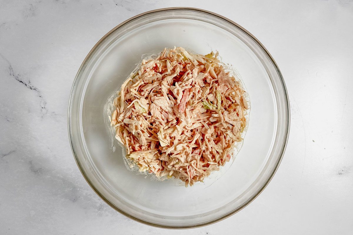 Cole Slaw For Taste Of Home Catfish Po'boy In A Glass Bowl On A Marble Surface.