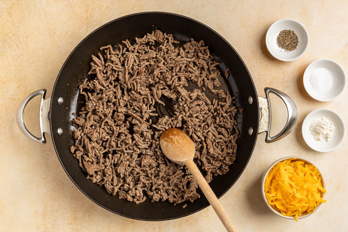 Taste of Home Cheeseburger Tacos recipe photo of the cooked ground beef, seasoning and cheddar cheese.