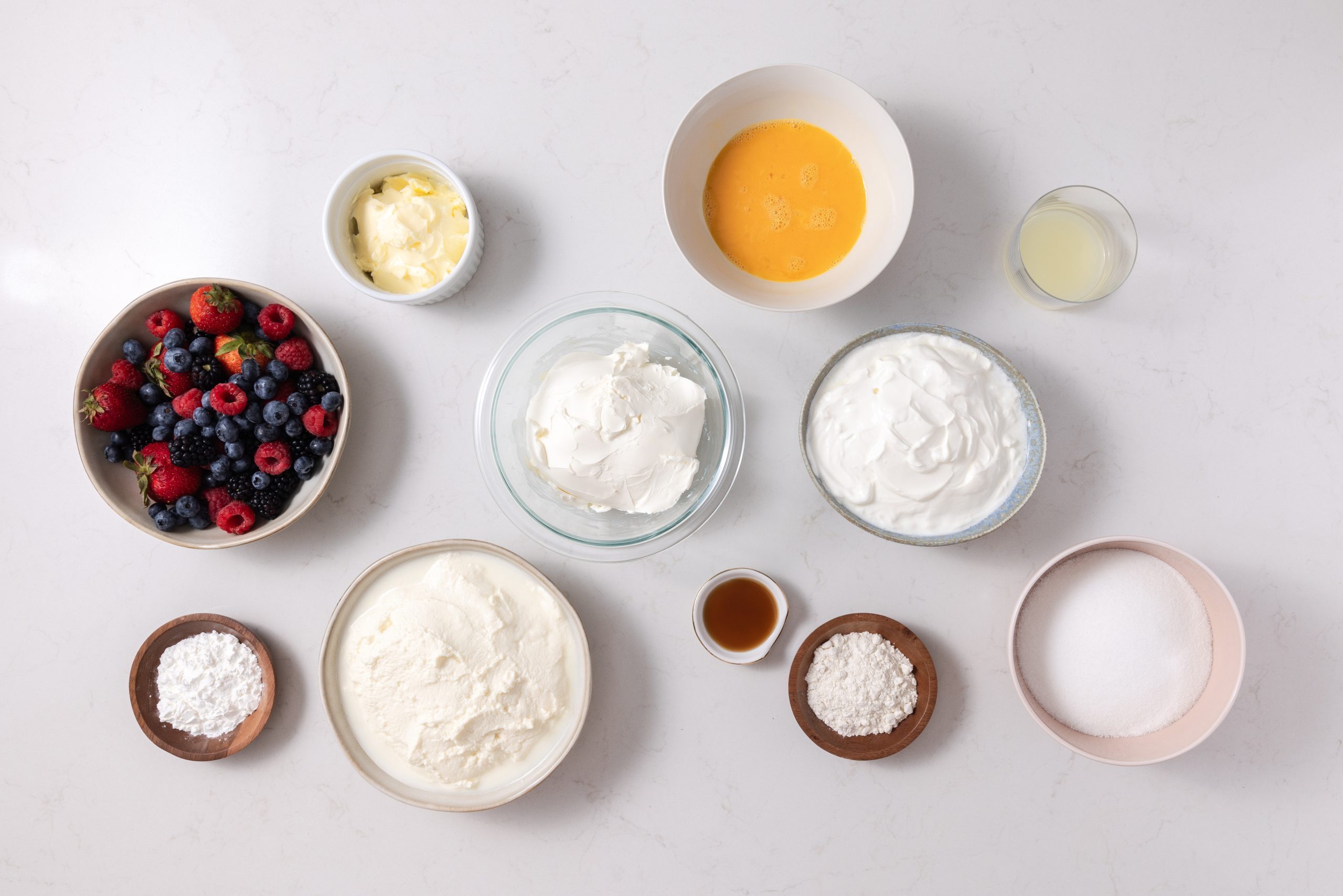 Ingredients for crustless cheesecake on kitchen counter.