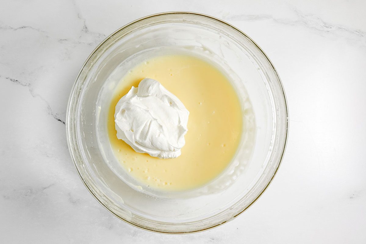 Filling ingredients for Taste of Home Easy Tiramisu in a glass bowl on a marble surface
