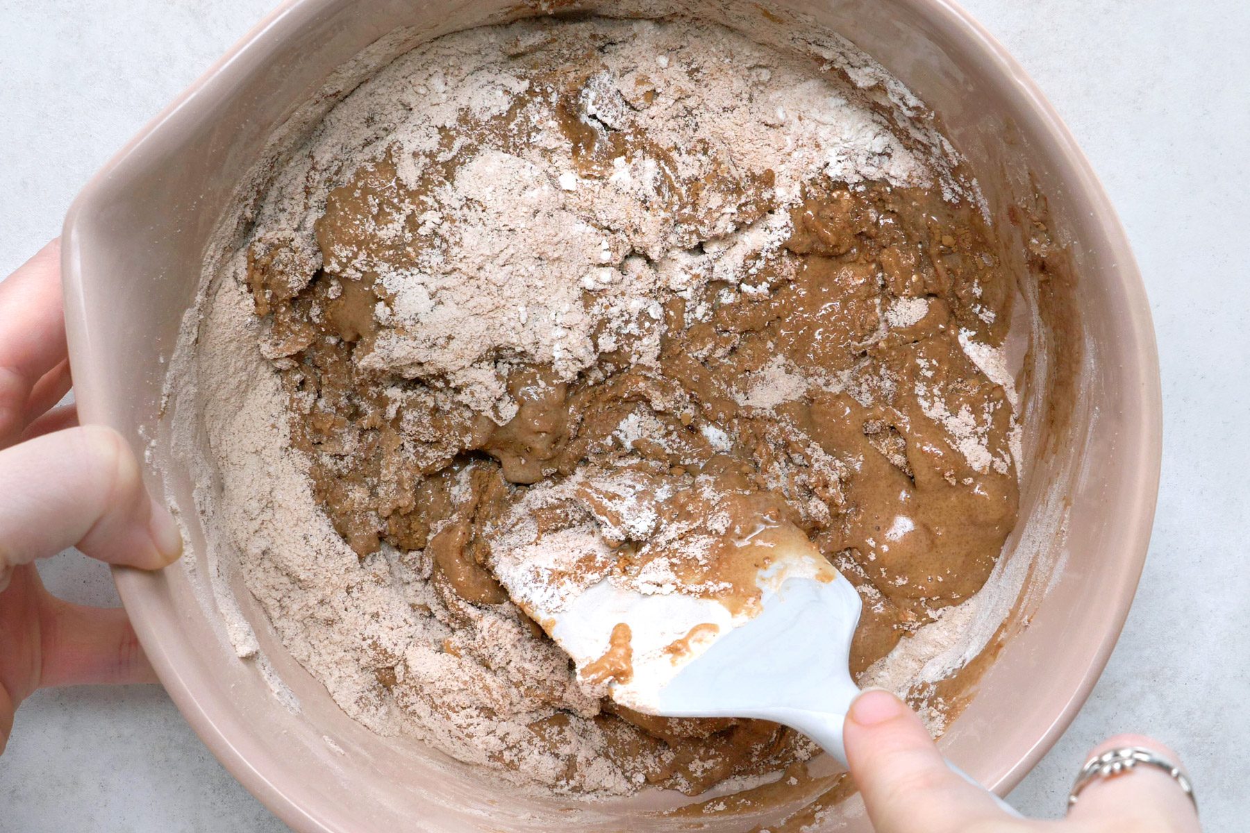 Milk, oil and vanilla mixture blended with a mixture of flour, sugar, cocoa, baking powder and salt.