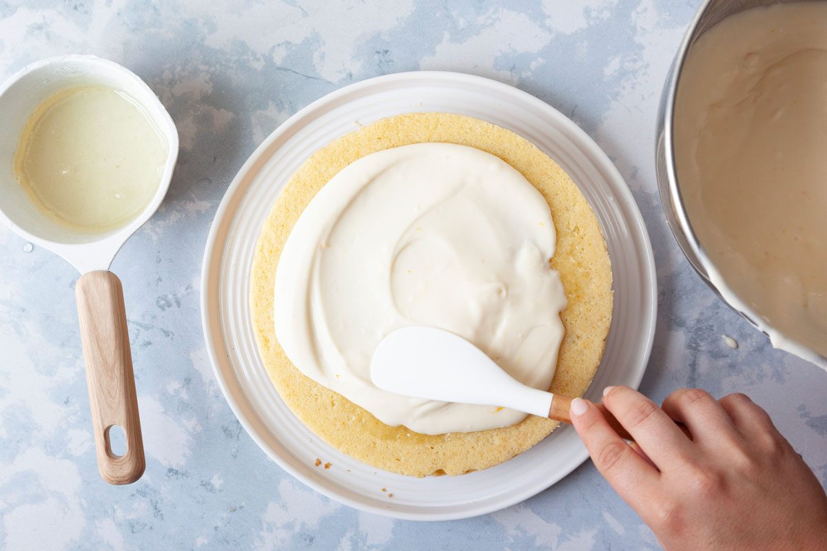 Step 5 of Taste of Home Italian Lemon Cream Cake is to place one cake layer on a serving plate. Brush with 2 tablespoons glaze and spread with a third of the filling. Repeat the layers. garnish with lemon zest.