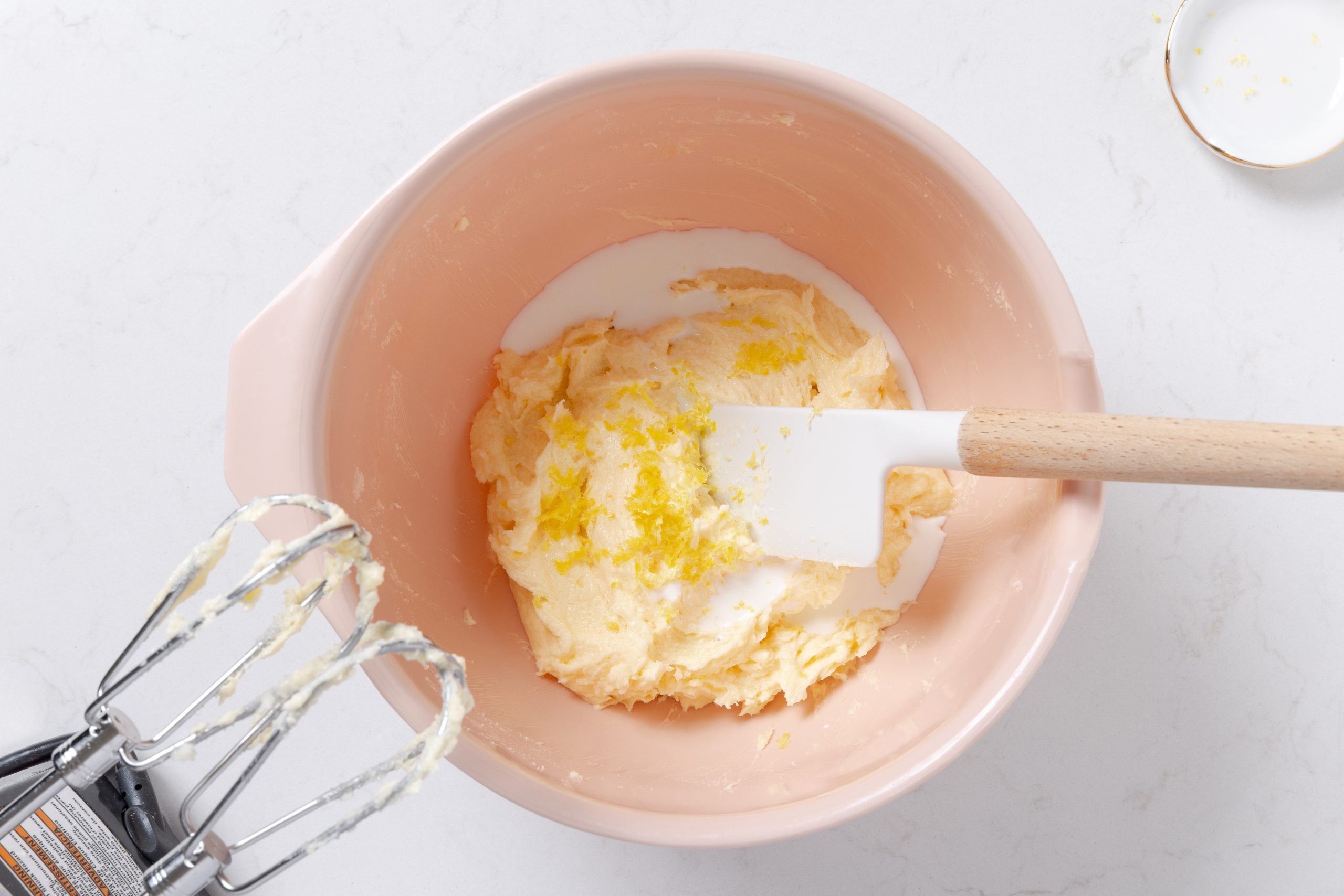 Mixing bowl with cookie batter being prepared.