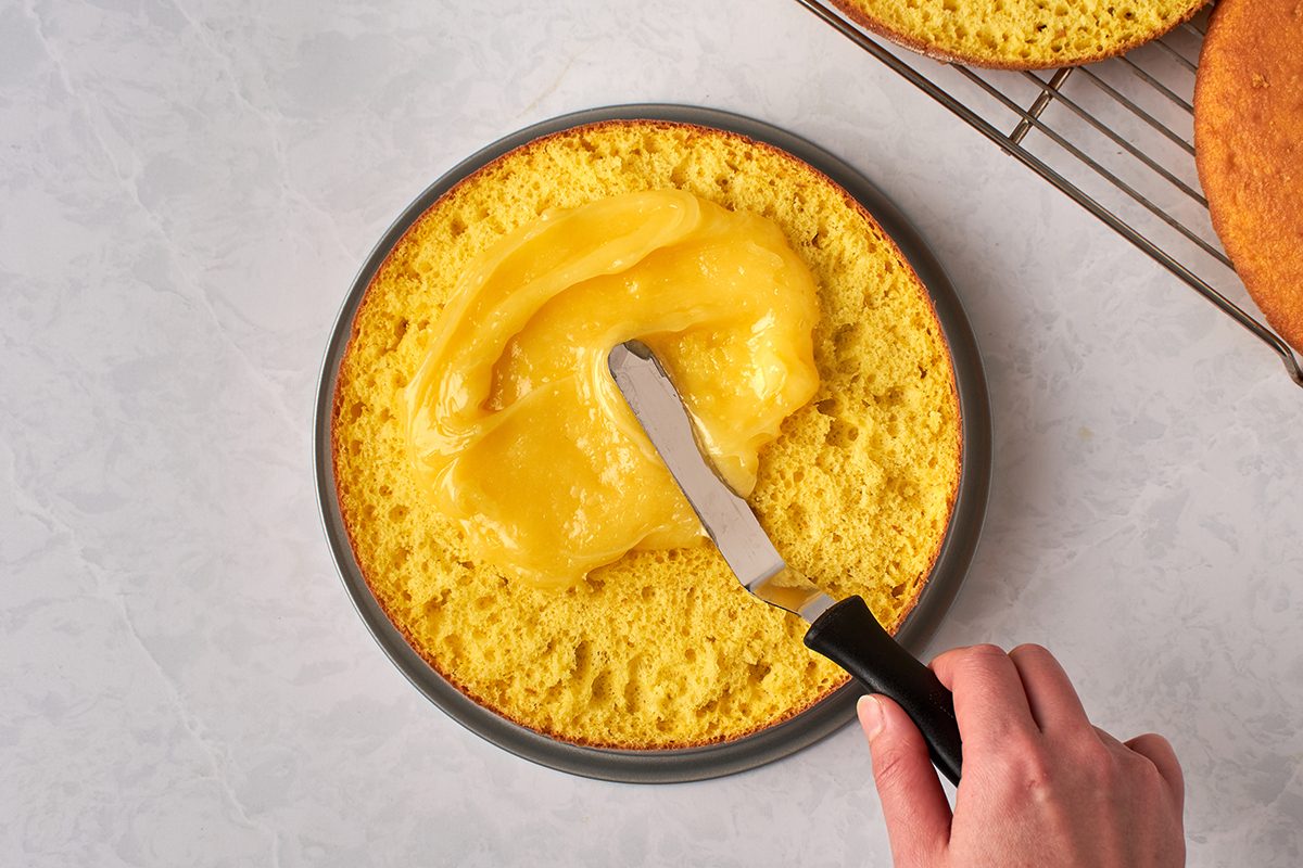 Spread lemon filling on cake