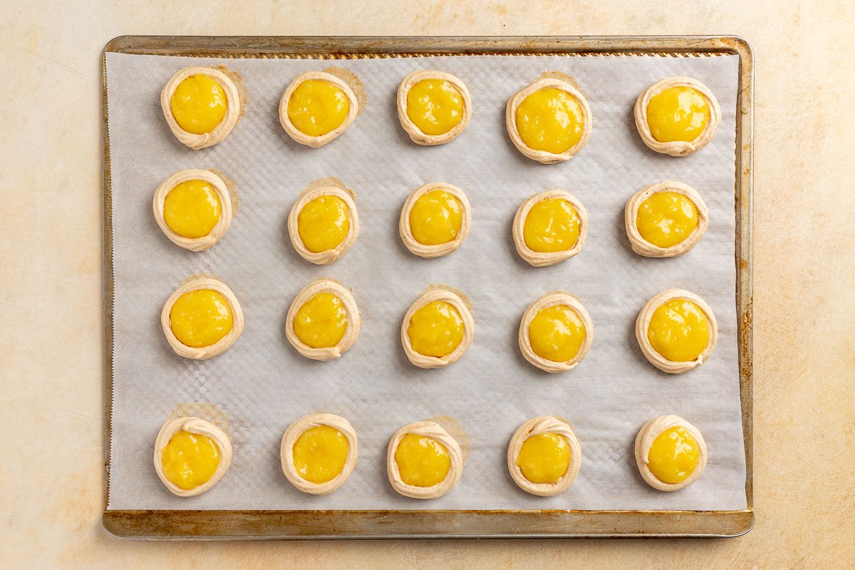 Taste of Home Lemon Meringue Cookies recipe photo of the lemon curd spooned into the center of the cookies.