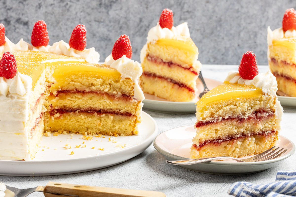 Taste of Home Lemon Raspberry Cake recipe photo of the cake cut into slices and served on plates.