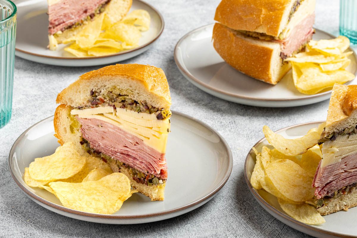 Taste of Home Muffuletta Recipe photo of the finished recipe cut into slices and served on plates.